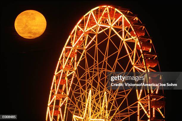 ferris wheel at night with full moon - neon joe stock pictures, royalty-free photos & images