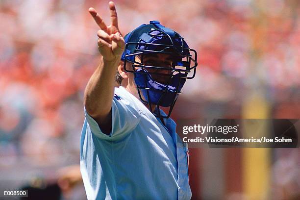 umpire holding up signal with hand - baseball umpire stock pictures, royalty-free photos & images