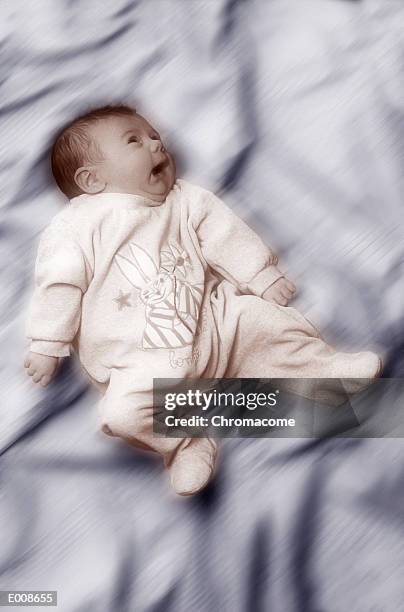 sad baby in bunny sleeper on blurred background - isolated colour stock pictures, royalty-free photos & images