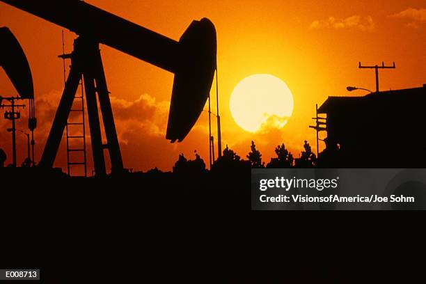 oil drill at sunset - torrance stock pictures, royalty-free photos & images