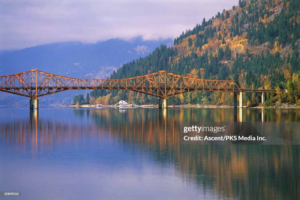 Cantilever bridge next to island with fall foliage