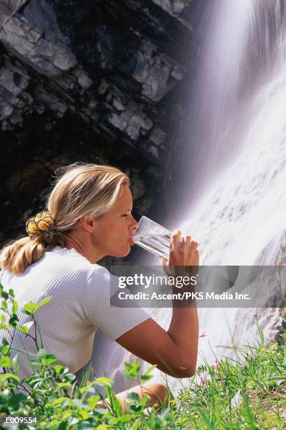 woman drinking clean water from glass - glass waterfall stock pictures, royalty-free photos & images