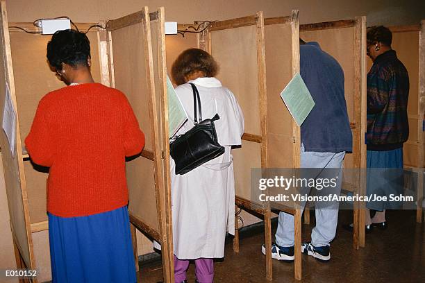 voters selecting candidates in voting booths - republican presidential nominee donald trump holds rally in new hampshire on eve of election stockfoto's en -beelden