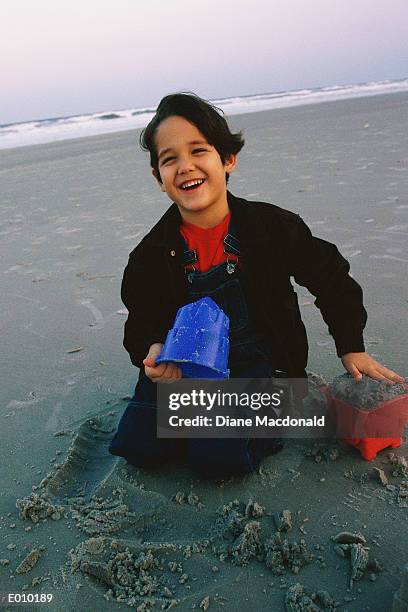 child making sandcastle on beach - sandy macdonald stock pictures, royalty-free photos & images