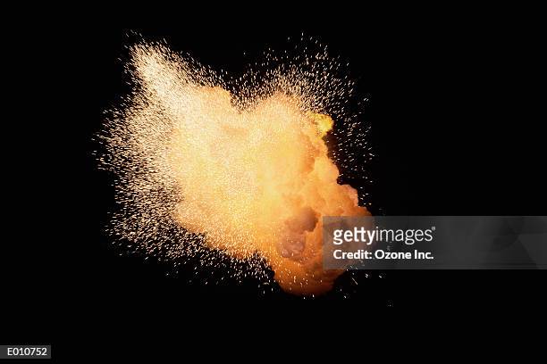 huge fireburst exploding with emanating sparks - sparks fotografías e imágenes de stock