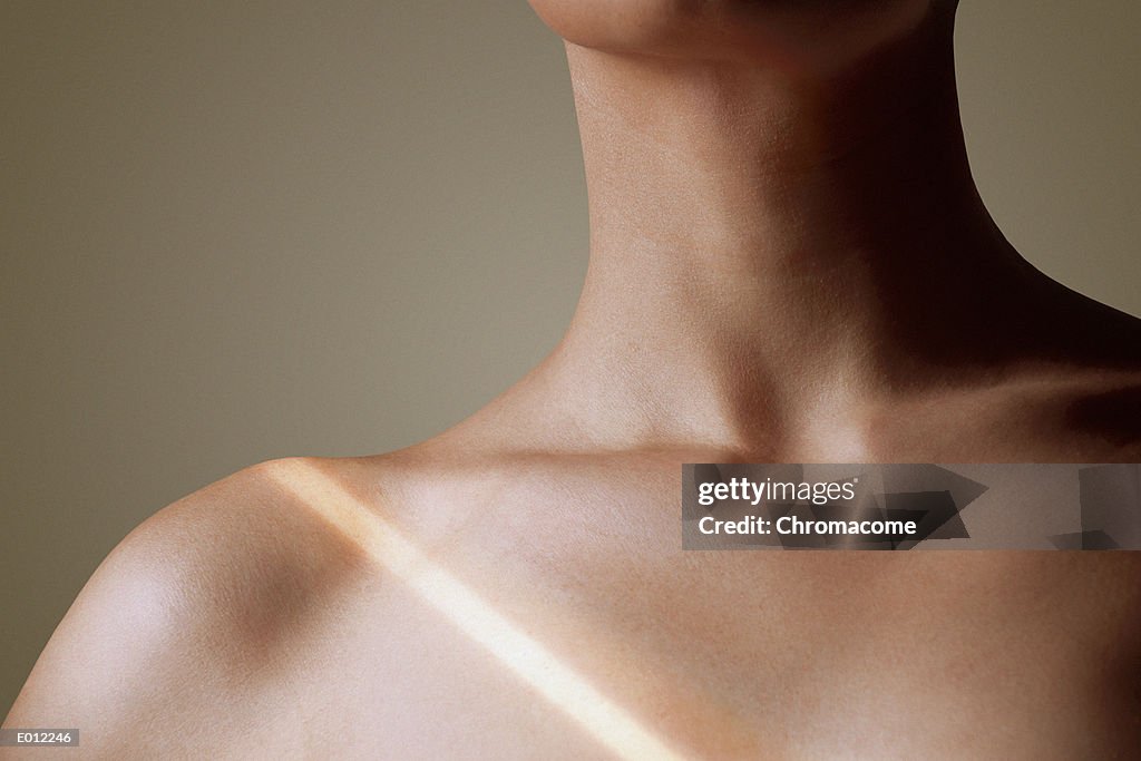 Collarbone of woman with light stripe