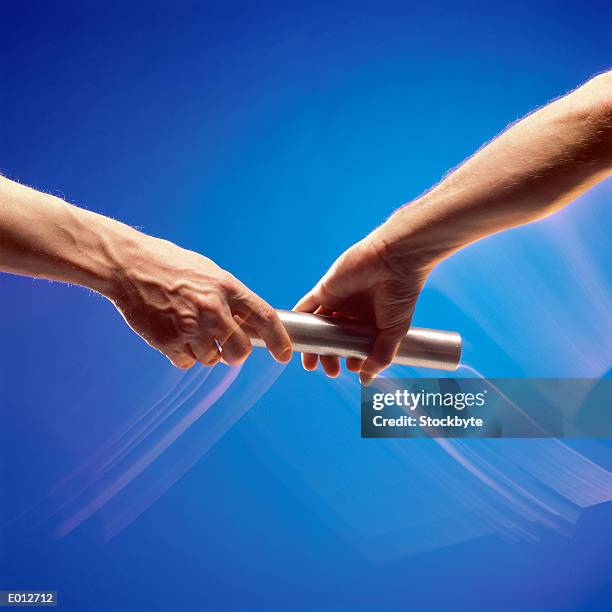 hands passing baton - sports competition format stock pictures, royalty-free photos & images