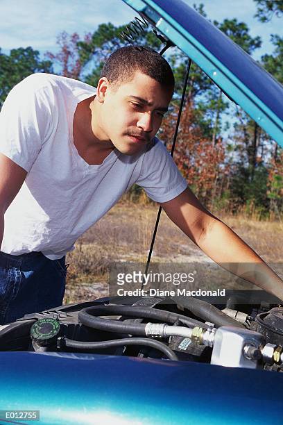 young man working under hood of car - diane ストックフォトと画像
