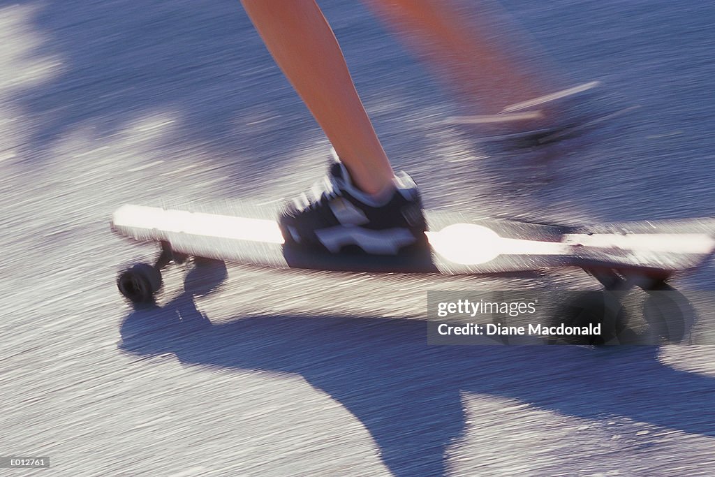 Feet on moving skateboard