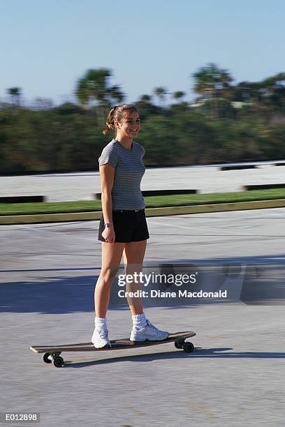 teenage girl riding skateboard - diane ストックフォトと画像