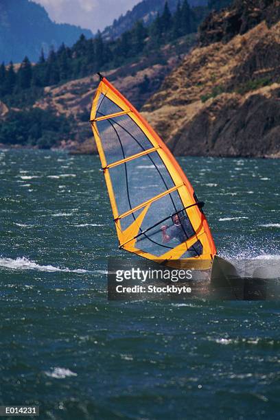 person windsurfing in lake - supreme fiction stock pictures, royalty-free photos & images