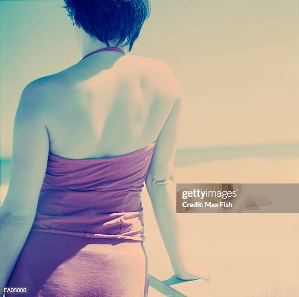 woman looking out to sea, rear view - max stock pictures, royalty-free photos & images