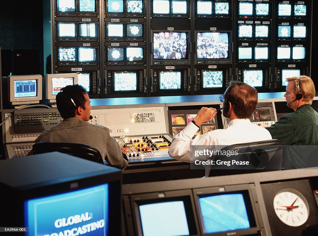 Television broadcast control room with director and crew