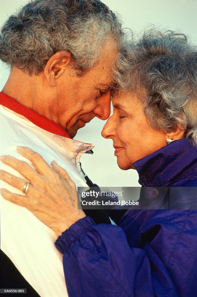 Mature couple embracing, profile, close-up