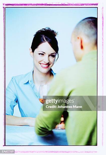 couple drinking wine, view over man's shoulder - mann fotografías e imágenes de stock