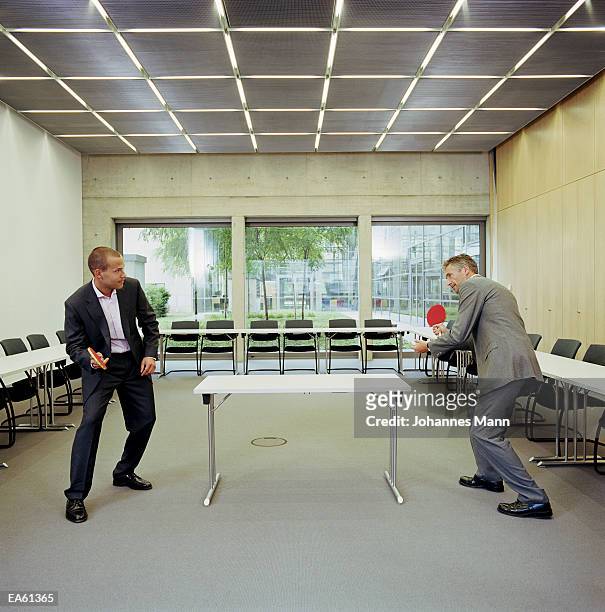 two businessmen playing table tennis - mann stock pictures, royalty-free photos & images