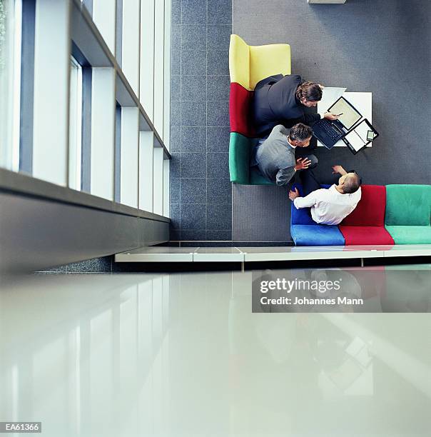 three businessmen in meeting, overhead view - mann fotografías e imágenes de stock