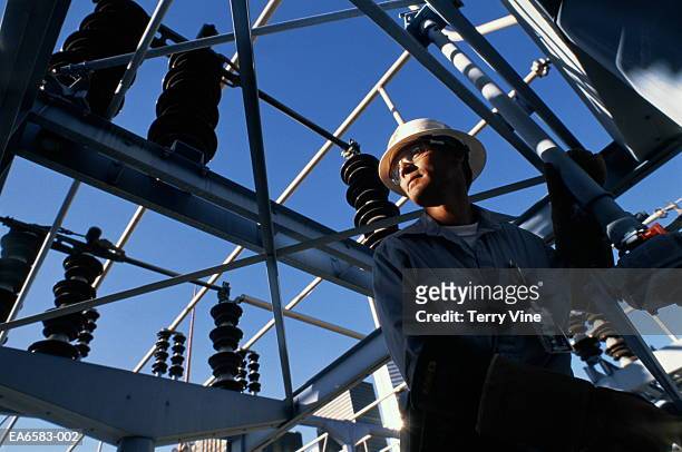 engineer at work in electricity  substation - energie strom stock-fotos und bilder