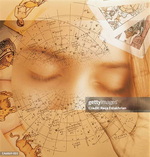 woman's eyes with astrological charts and tarot cards (composite) - tarot cards stock-fotos und bilder