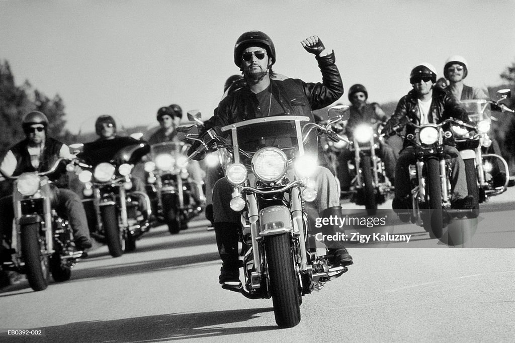 Man on motorcycle leading motorcycle gang (B&W)