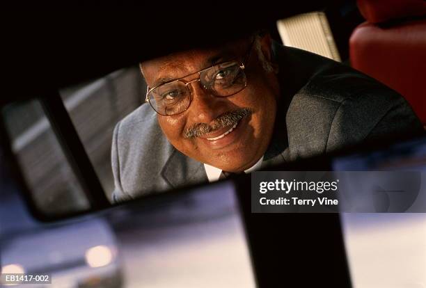 bus driver in rear-view mirror, portrait - vehicle mirror stock-fotos und bilder