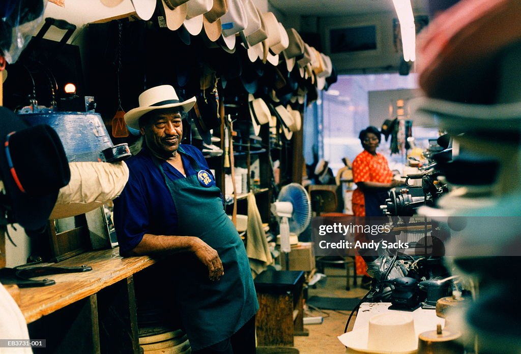 Hat maker in his shop, wife in background, Tennessee, USA