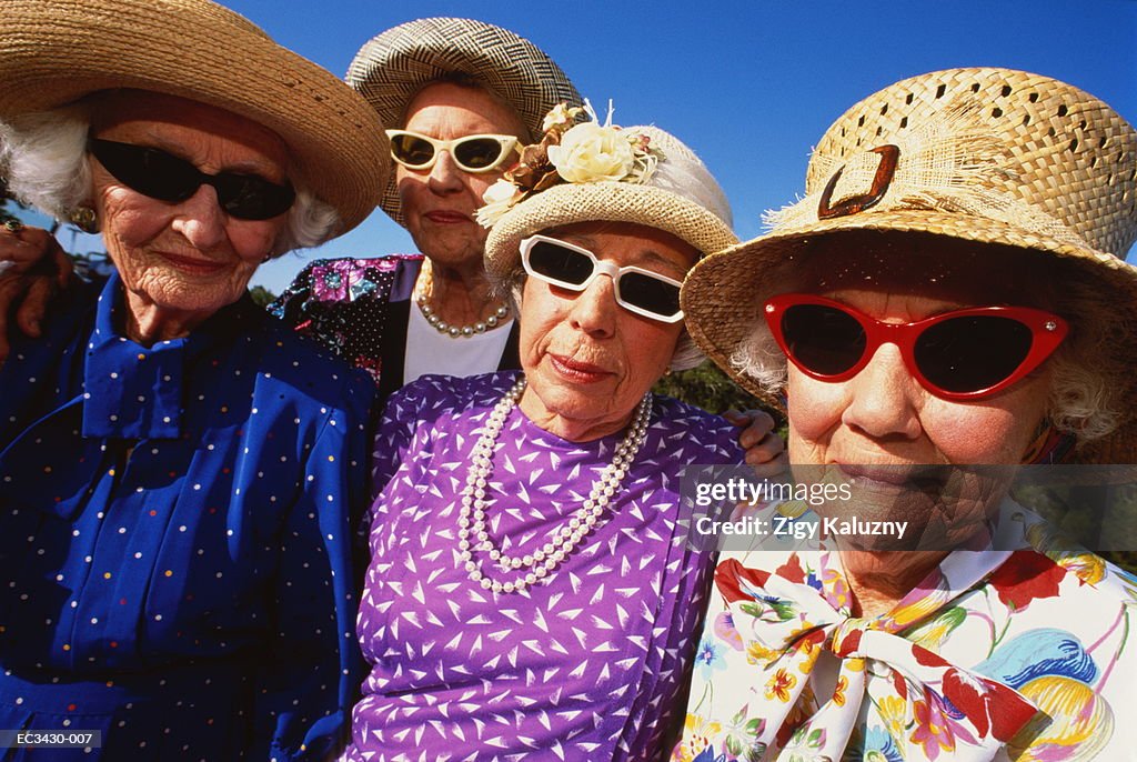 Elderly women wearing hats and sunglasses, outdoors (wide angle)