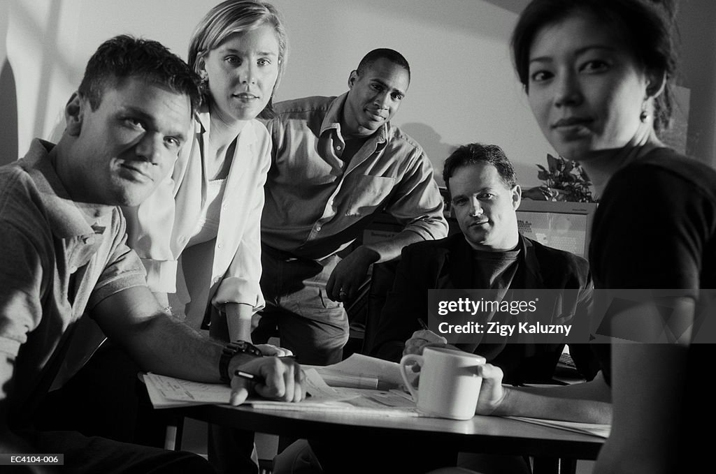 Young business executives in meeting, portrait (B&W)