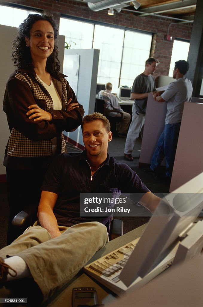 Young man and woman in office, portrait