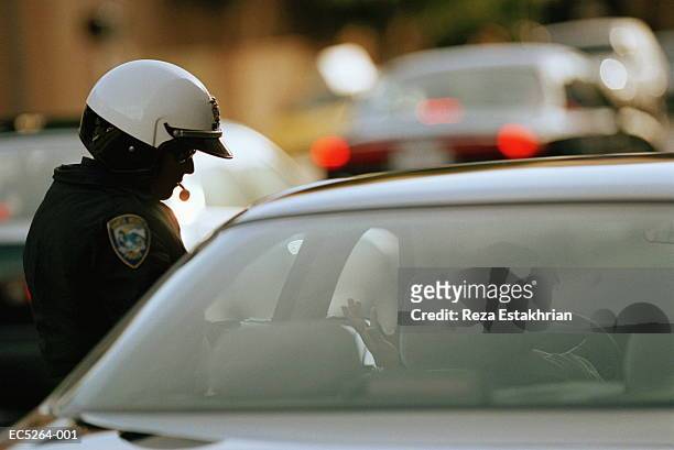 police officer talking to commuter (enhancement) - traffic cop stock pictures, royalty-free photos & images