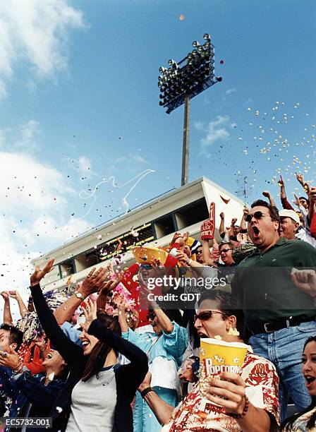 stadium crowd cheering, confetti in air - crowd cheering outside stock pictures, royalty-free photos & images