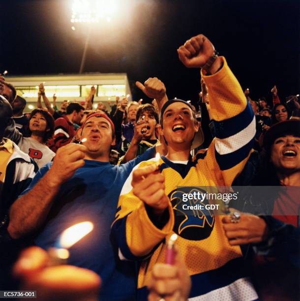 concert crowd holding lighters during show - lighters at concert stock pictures, royalty-free photos & images