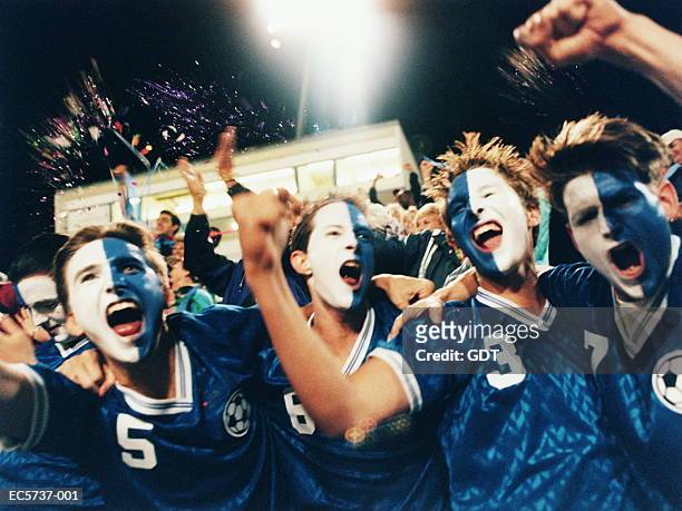 soccer fans cheering in stadium, men with painted faces - face paint stock pictures, royalty-free photos & images
