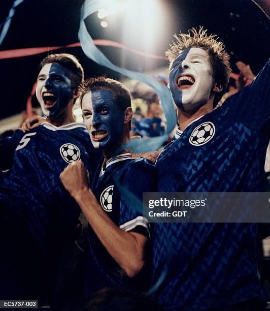 soccer fans with painted faces in stadium - cu fan stock pictures, royalty-free photos & images