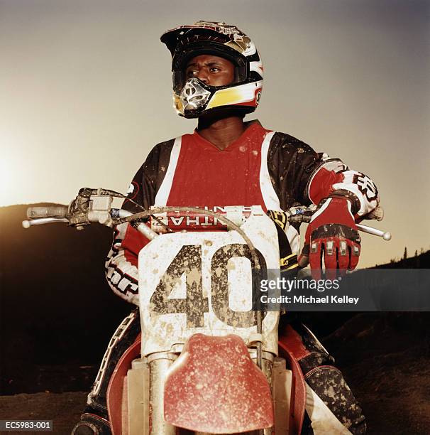 man wearing protective gear, sitting on motorcross bike - motocross gear stock pictures, royalty-free photos & images