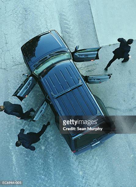 men in black suits running from sports utility vehicle, overhead view - open day 3 stock pictures, royalty-free photos & images