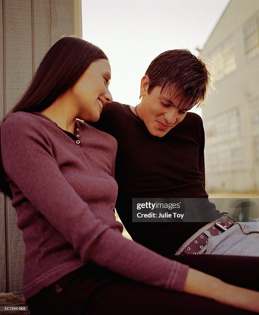 Couple sitting outside warehouse