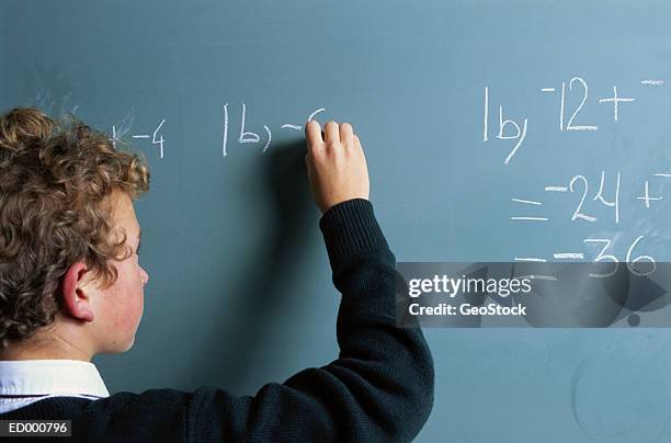 Kid Writing Down Math Math 128 Young Boy Writes Math Equations On Chalkboard Stock Photos, High ...