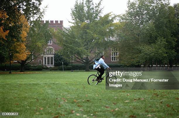 student riding bike on campus - 9927 stock pictures, royalty-free photos & images
