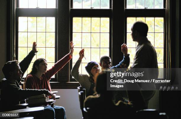 students raising hands in college class - jerry lewis hosts special screening of the nutty professor stockfoto's en -beelden