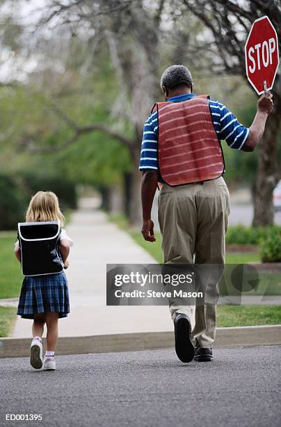 crossing guard with girl - 交通誘導員 ストックフォトと画像