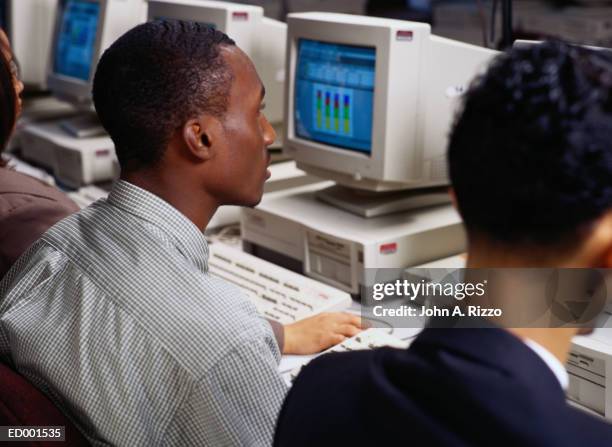 man sitting before computer - computer training classes stock pictures, royalty-free photos & images