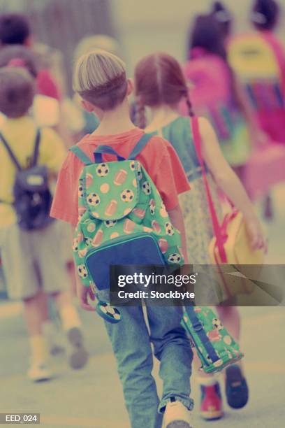 back view of group of children walking, all wearing knapsacks - all stock pictures, royalty-free photos & images