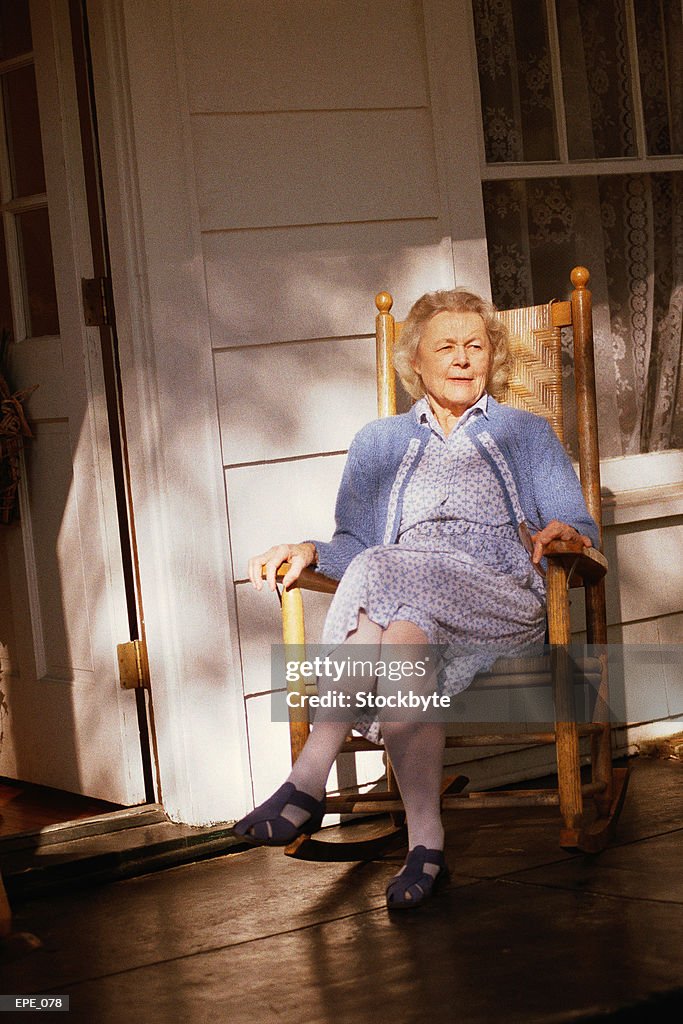 Person Sitting In Rocking Chair Woman Sitting In Rocking Chair On Porch High-Res Stock Photo - Getty Images
