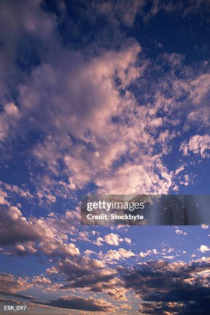 scattered altocumulus and cumulus clouds - stratocumulo foto e immagini stock