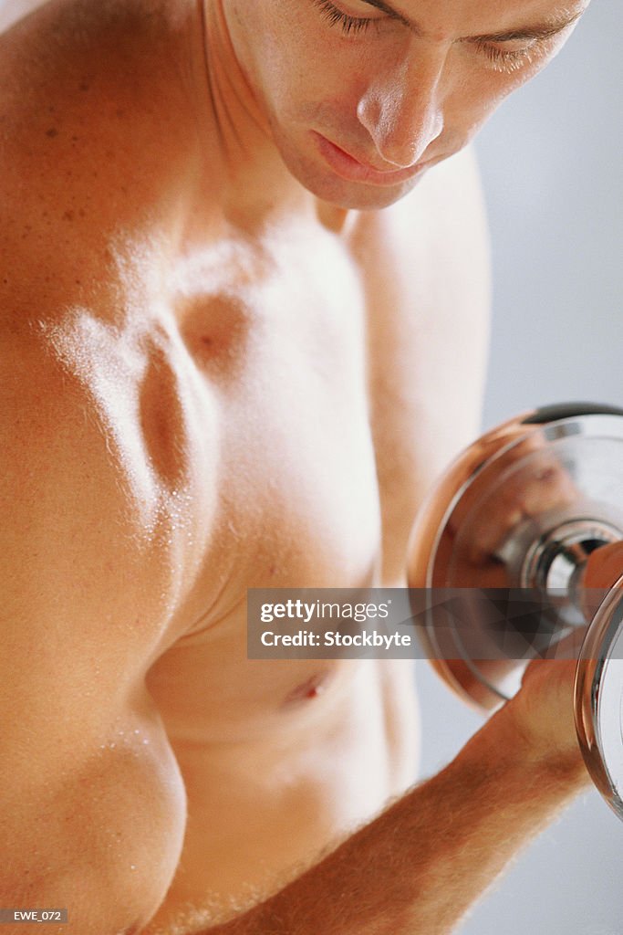 Man holding dumbbell flexing