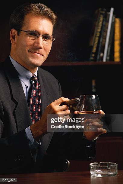 man holding snifter glass - konjaksglas bildbanksfoton och bilder