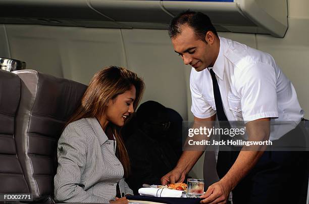 flight attendant serving passenger - plane food stock pictures, royalty-free photos & images