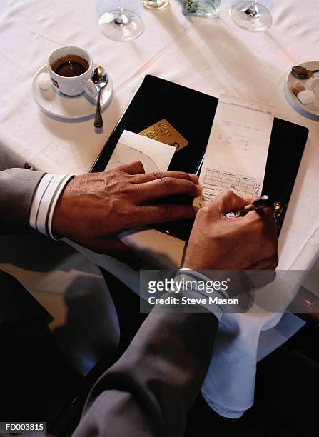 man paying restaurant check, elevated view, close-up - check up ストックフォトと画像