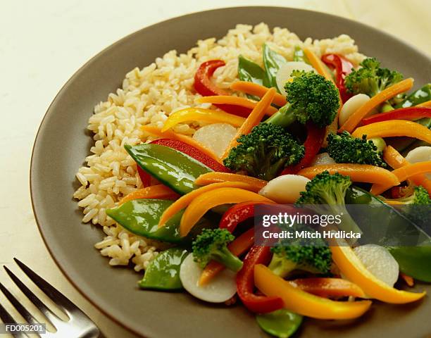 close-up of vegetable stir-fry and brown rice - macrobiotic diet stock pictures, royalty-free photos & images